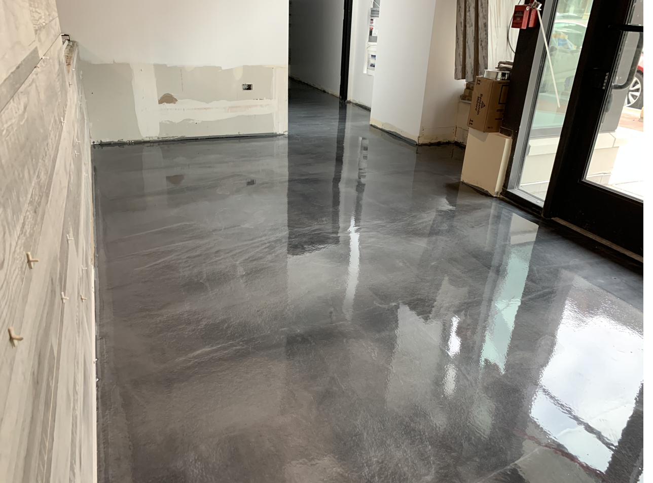 Metallic epoxy floor in a retail storefront buildout