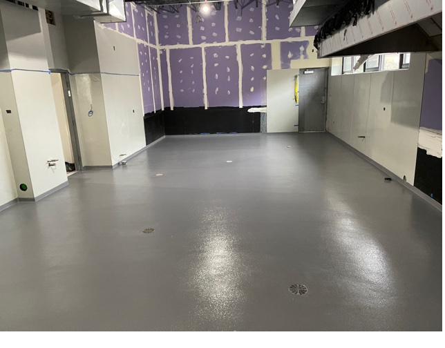 Gray epoxy floor installed in a room being renovated