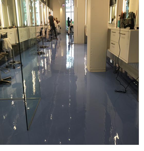 Blue metallic epoxy floor inside a salon